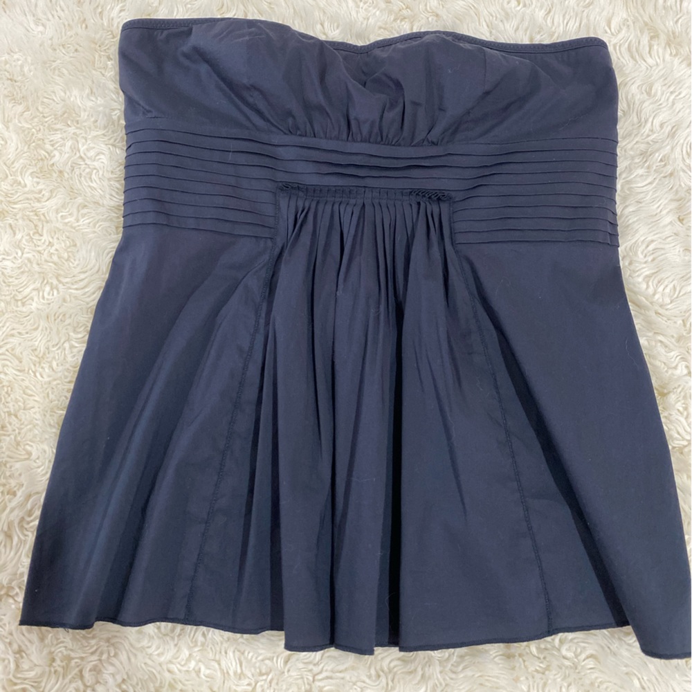 Strapless top with pleat detail.